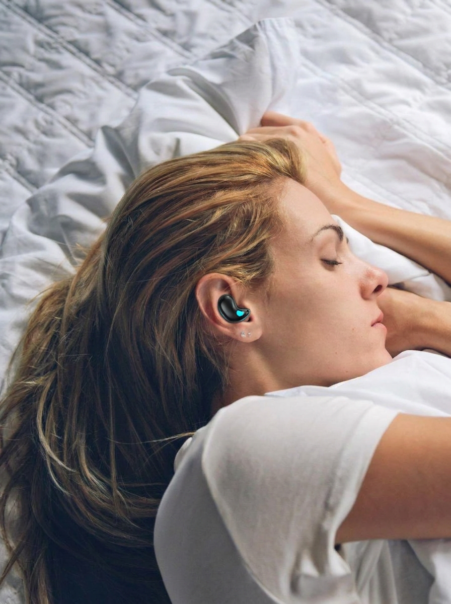 Woman resting on white linen sheets wearing Zavelian sleep earbuds